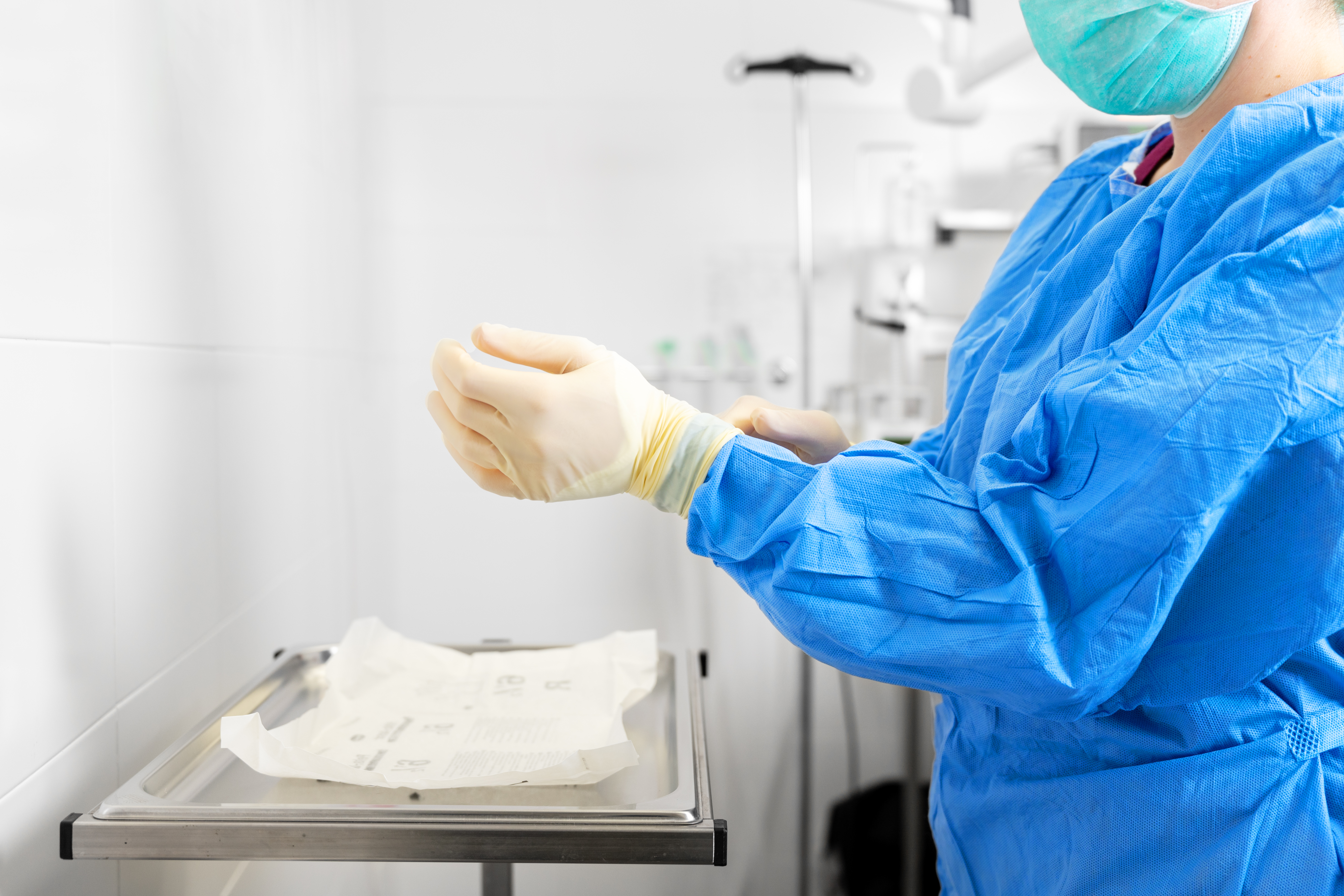 How can hand hygiene and sterile gloves reduce the risk of healthcare-acquired infections?